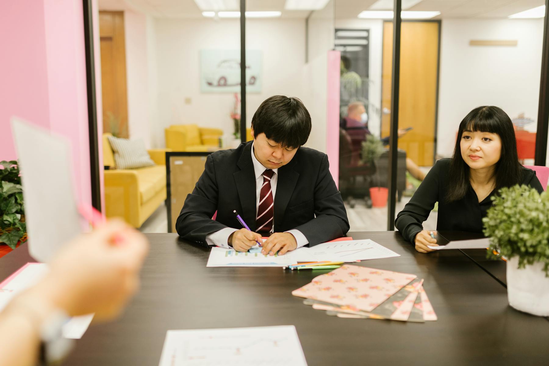 Business team in office strategy meeting around shared documents
