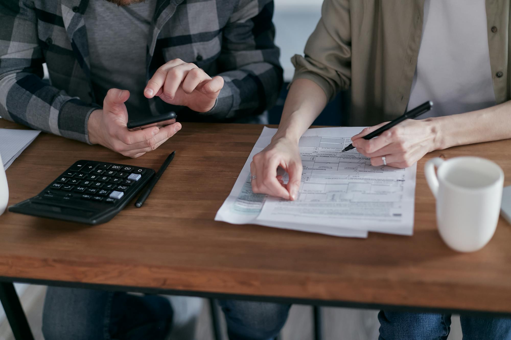 Professionals preparing tax documents and computing figures